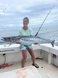 A women showing a wahoo fish caught on the Pez Loco fishing boat in Quepos, Costa Rica